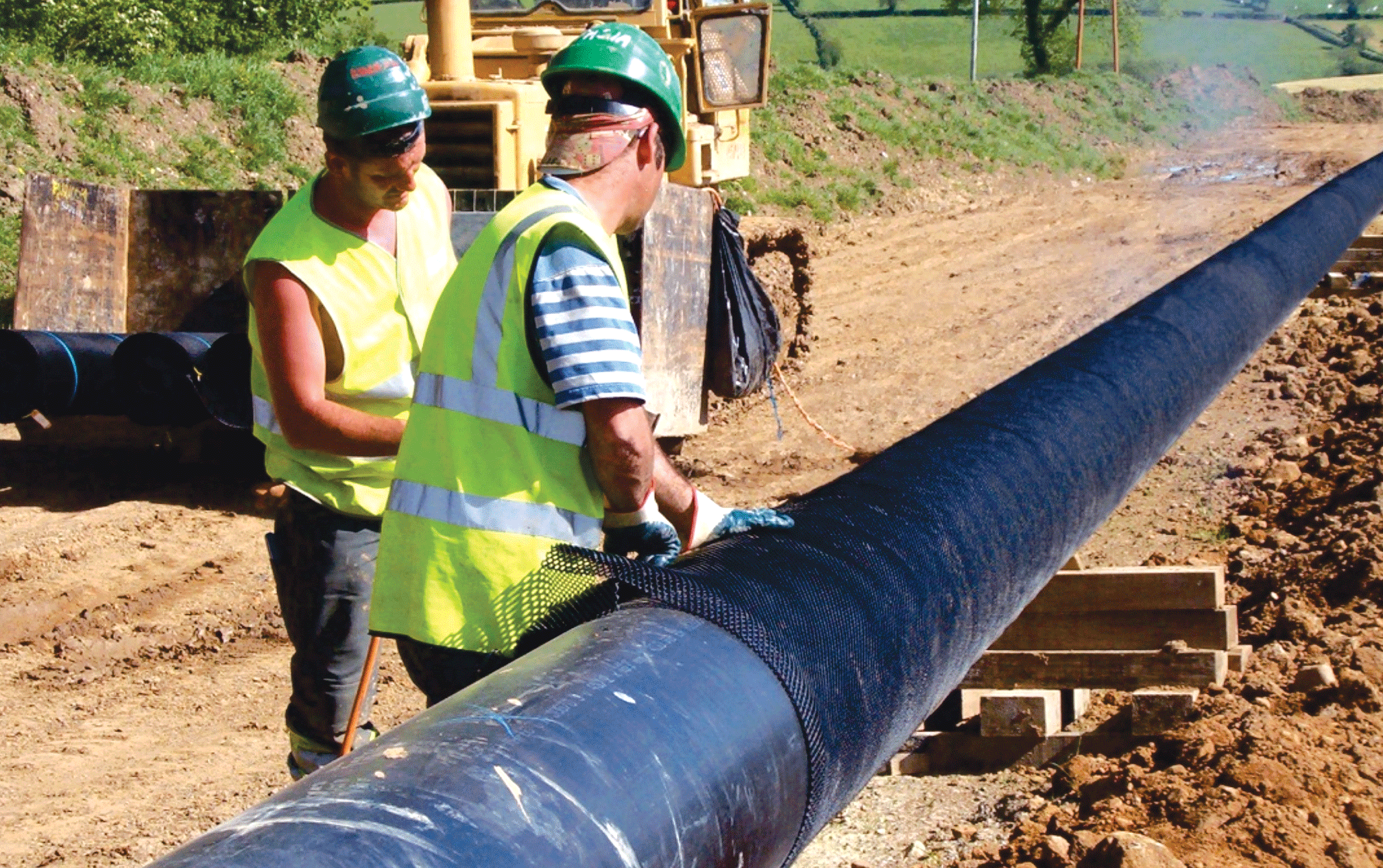 a group of men wearing safety vests and helmets for rockshield installation