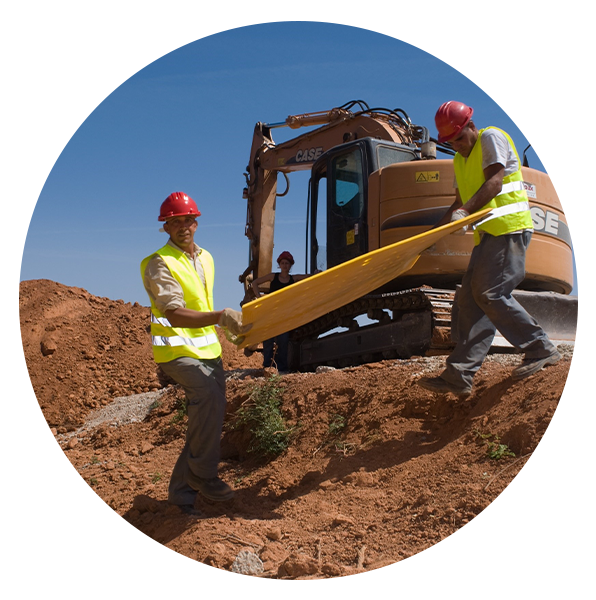 Two men carrying overpipe plates