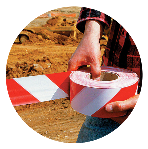 a person holding a roll of red and white tape